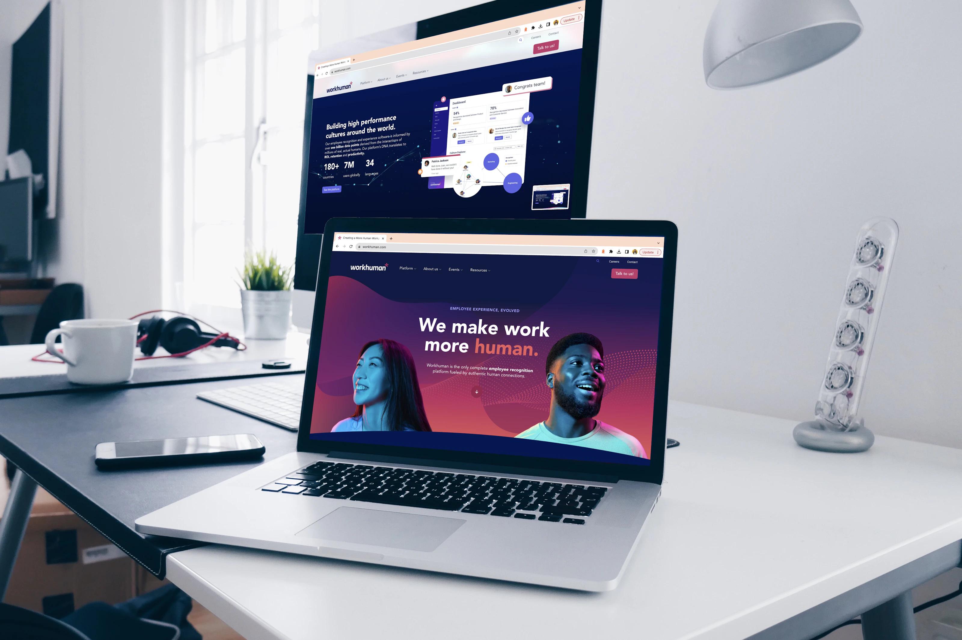 a desktop and a laptop are open to a web browser of the new Workhuman website