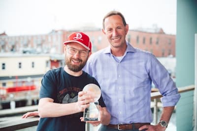 Maine Foreign Investor of the Year, Adapt Agency - Doug and Wade smiling and accepting trophy