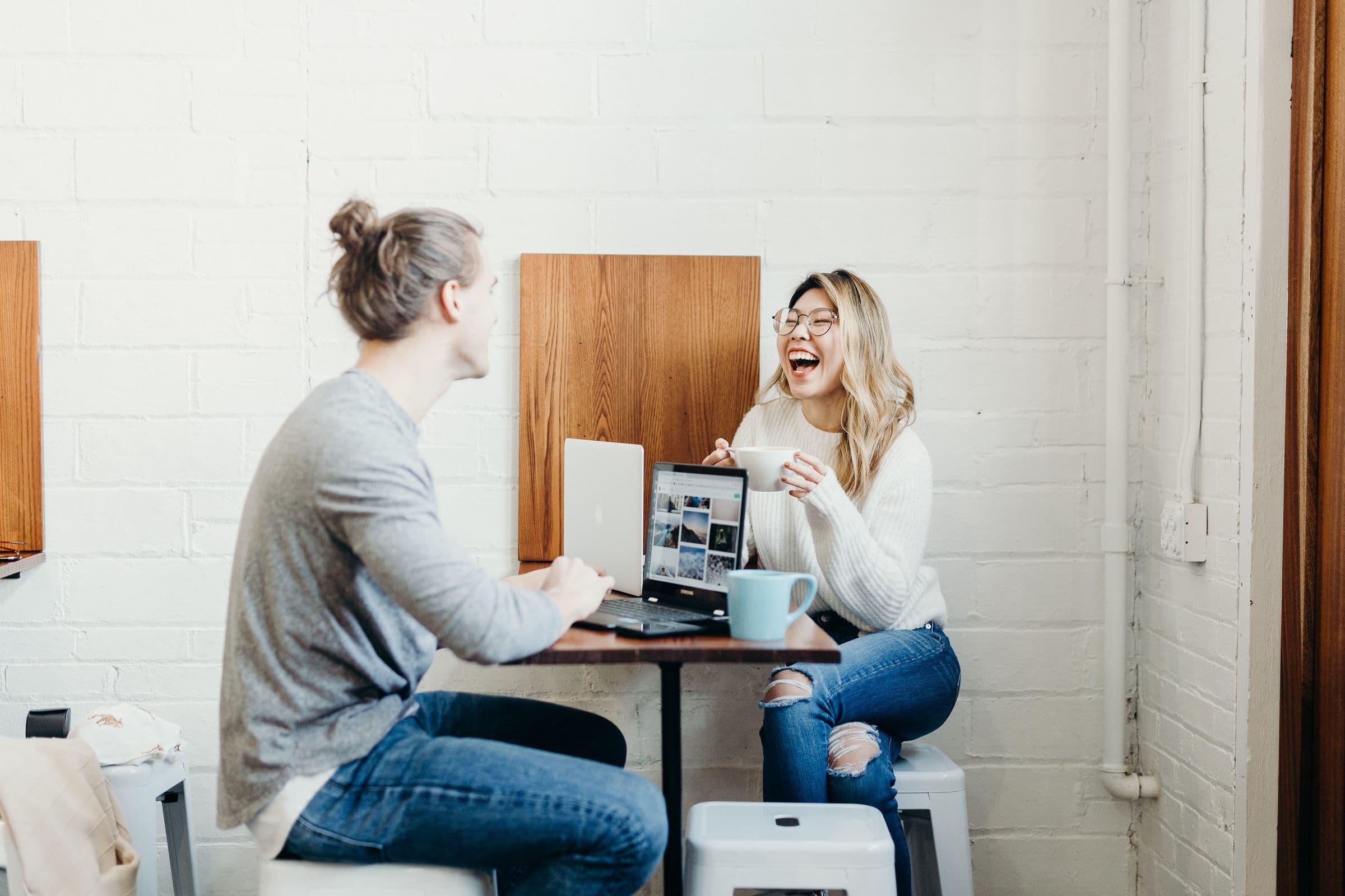 two people laughing together at work