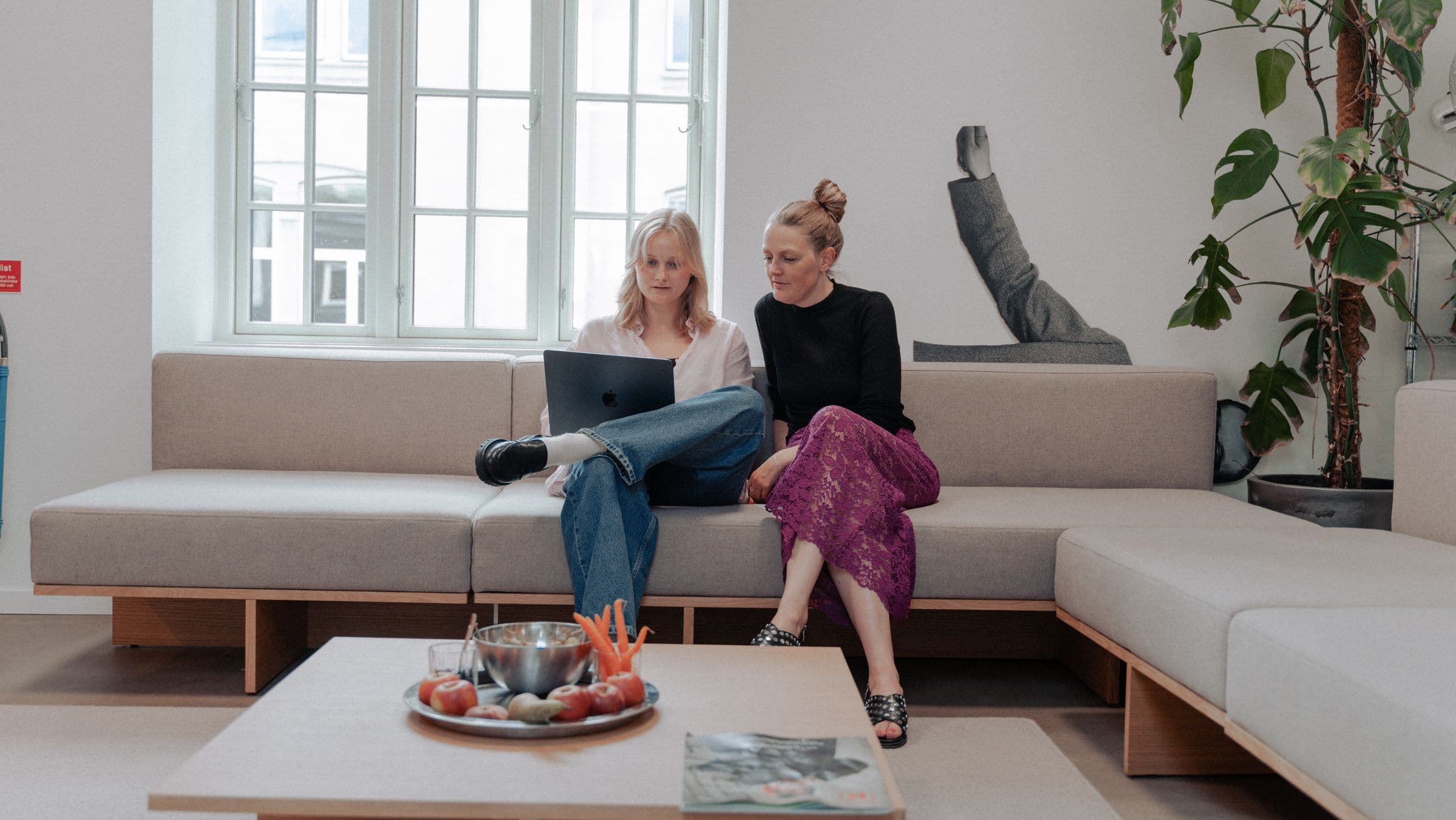 Two women working on couch